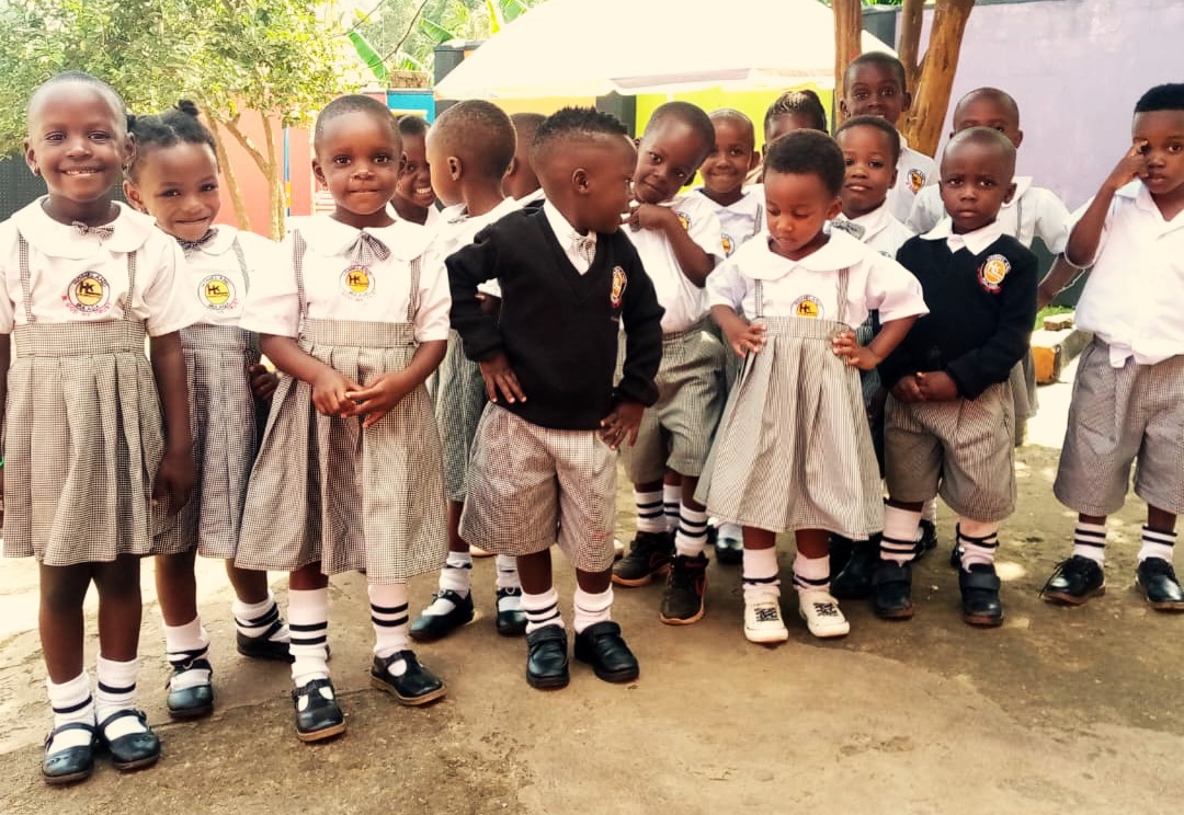 Volunteers helping children receive school supplies in Kampala Uganda